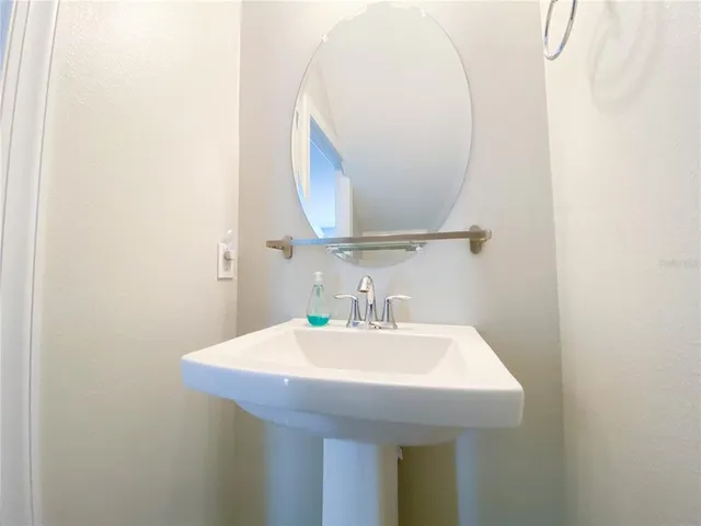 a bathroom with a sink and mirror