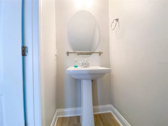 a bathroom with a granite countertop toilet a sink and a mirror
