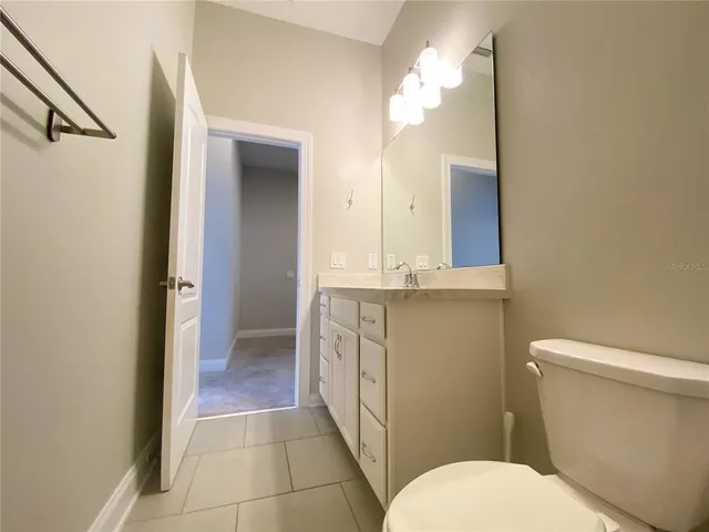 a bathroom with a sink toilet vanity and shower