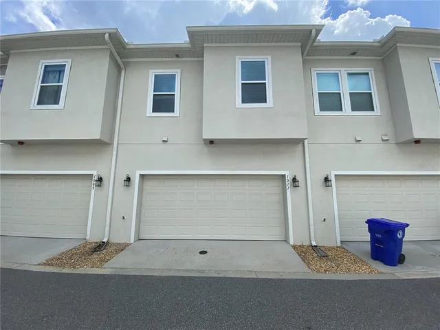 a view of a house with garden and trees