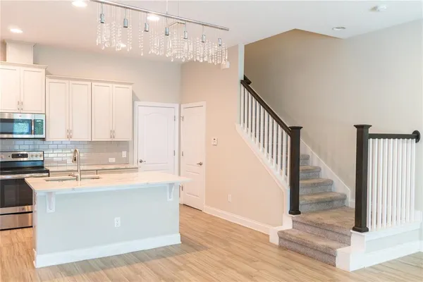 a kitchen with stainless steel appliances granite countertop a refrigerator and a stove