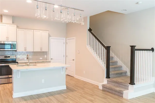 a kitchen with stainless steel appliances granite countertop a refrigerator and a stove