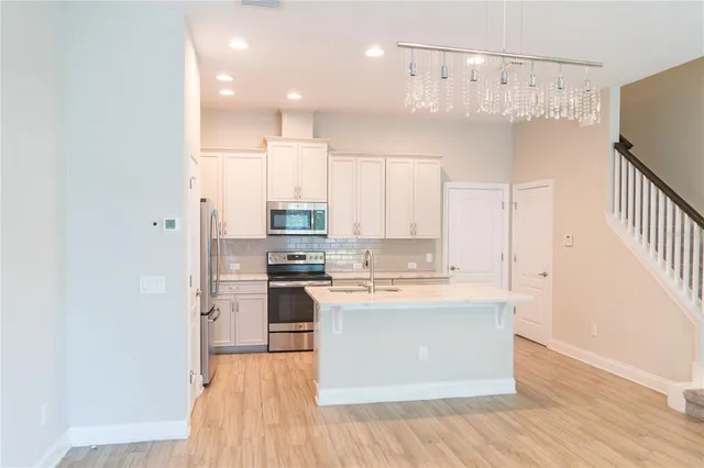 a metallic refrigerator freezer sitting in a kitchen