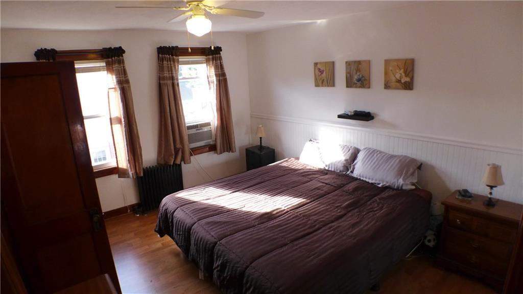 1097 Broughton Road Pittsburgh, PA 15236 - Photo 12 of 25 Bedroom 2 of 3. Lighted ceiling fan, natural woodwork.