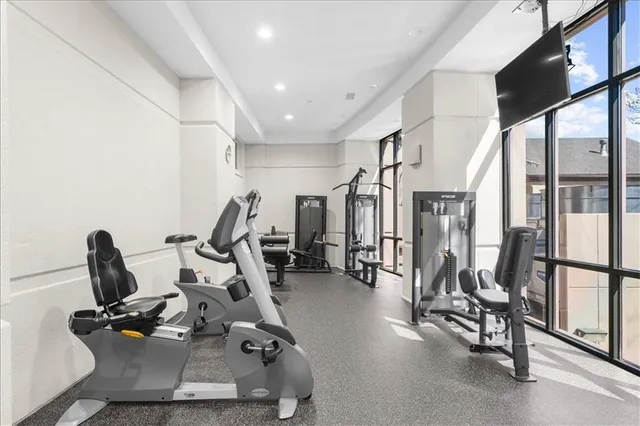 a room with gym equipment and a mirror