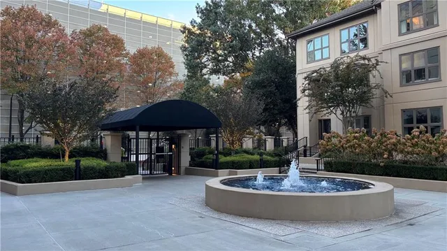 a view of house with outdoor space and tall trees