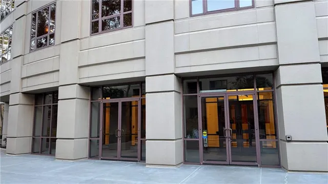 a dining room with furniture and a kitchen view