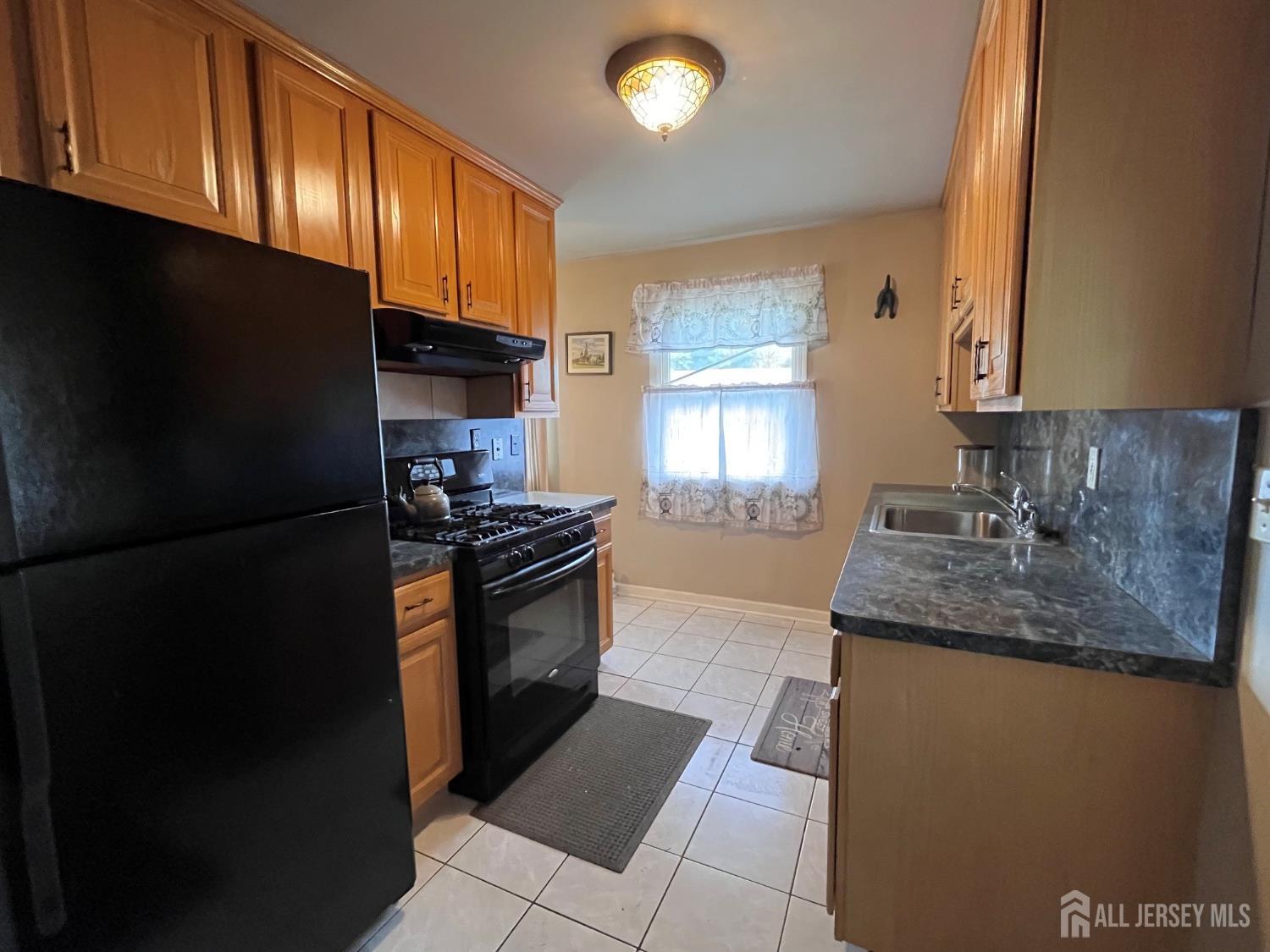 11 Purdue Road Old Bridge, NJ 08859 - Photo 3 of 14 a kitchen with granite countertop a refrigerator stove and microwave
