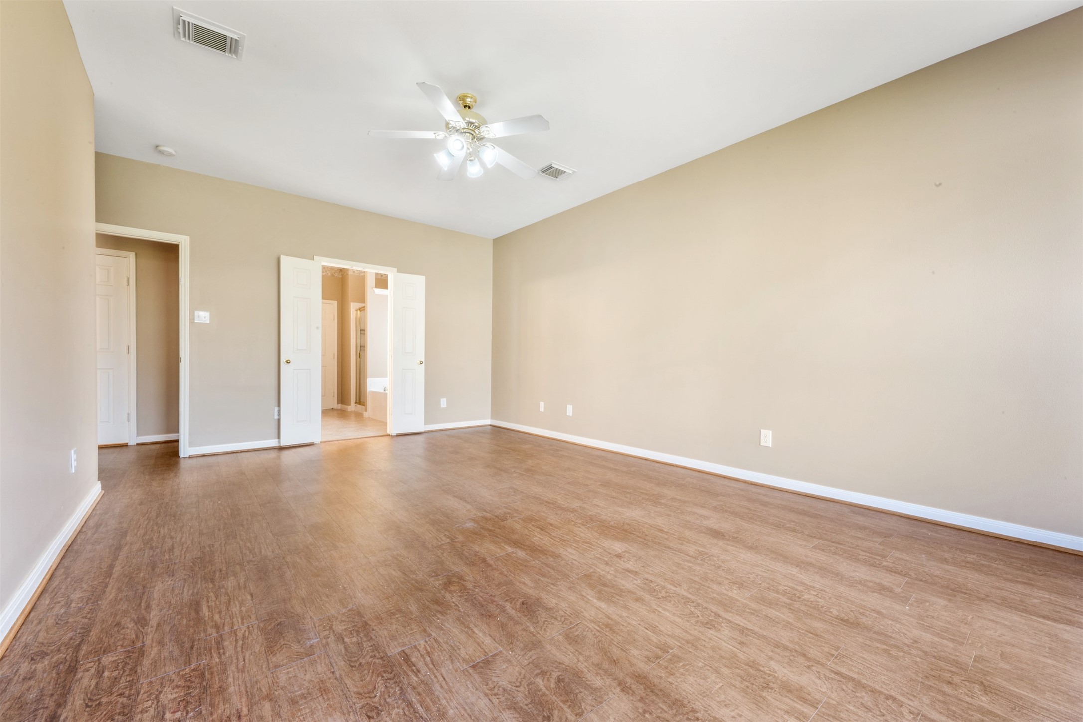 7023 Timber Edge Lane Humble, TX 77346 - Photo 14 of 37 an empty room with wooden floor and chandelier fan