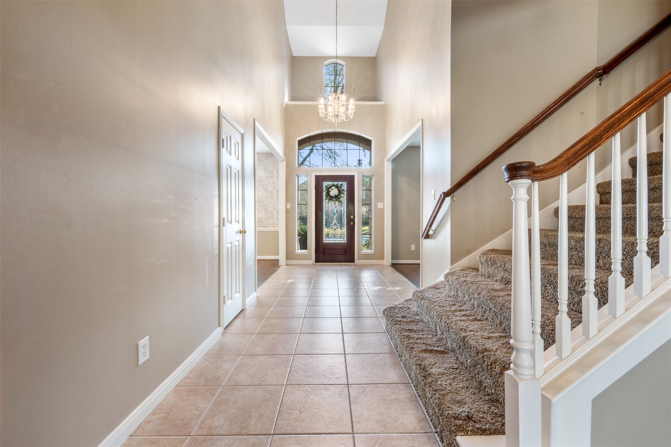7023 Timber Edge Lane Humble, TX 77346 - Photo 2 of 37 a view of a hallway with entryway windows a chandelier and a living room