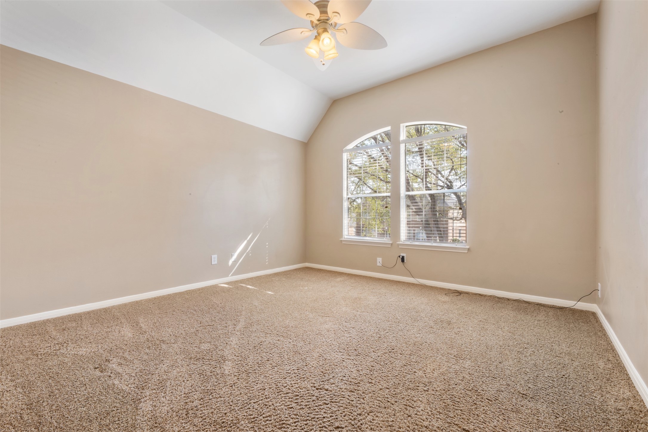 7023 Timber Edge Lane Humble, TX 77346 - Photo 22 of 37 an empty room with windows and chandelier fan