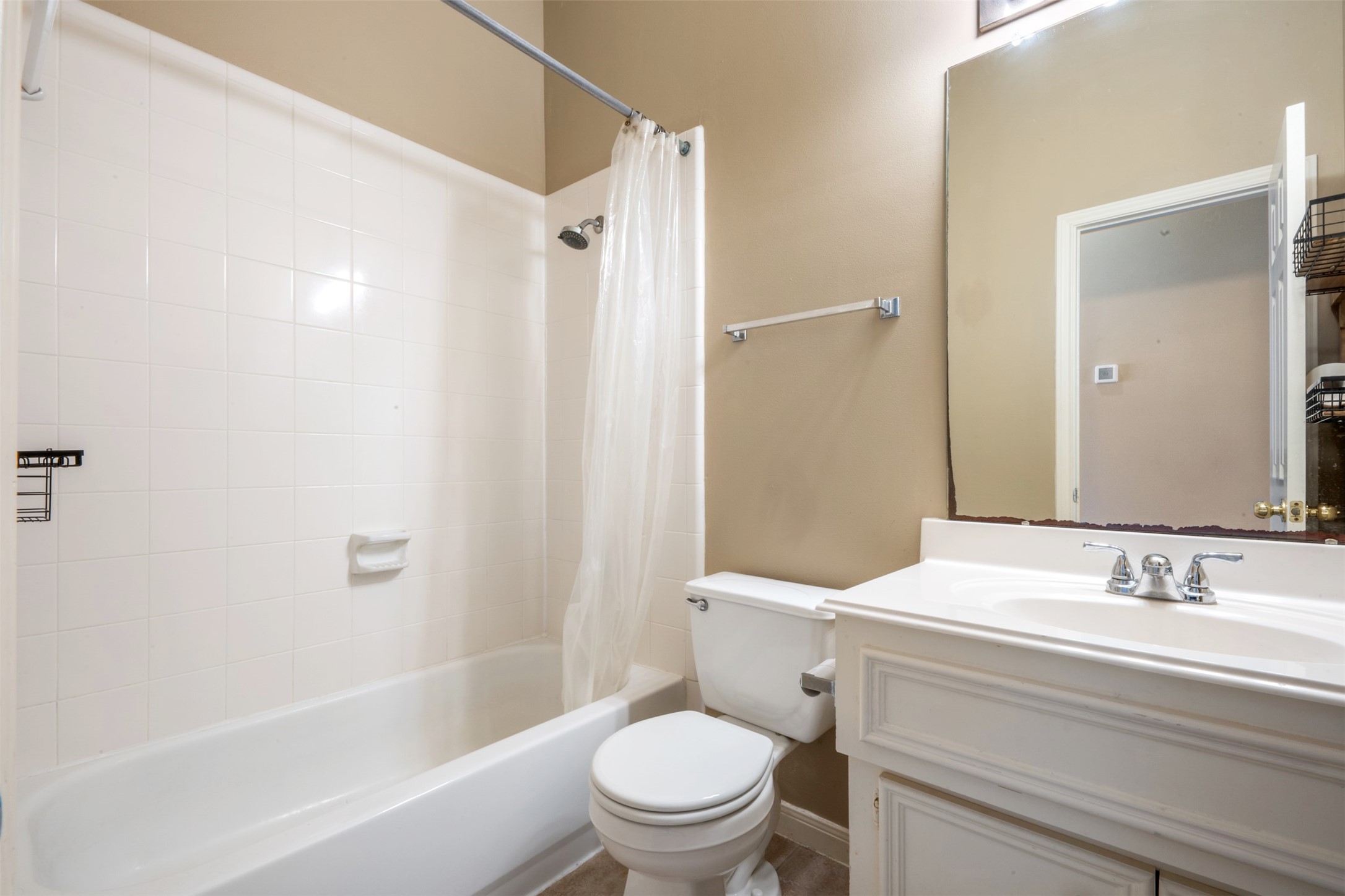 7023 Timber Edge Lane Humble, TX 77346 - Photo 23 of 37 a bathroom with a sink a toilet and a mirror