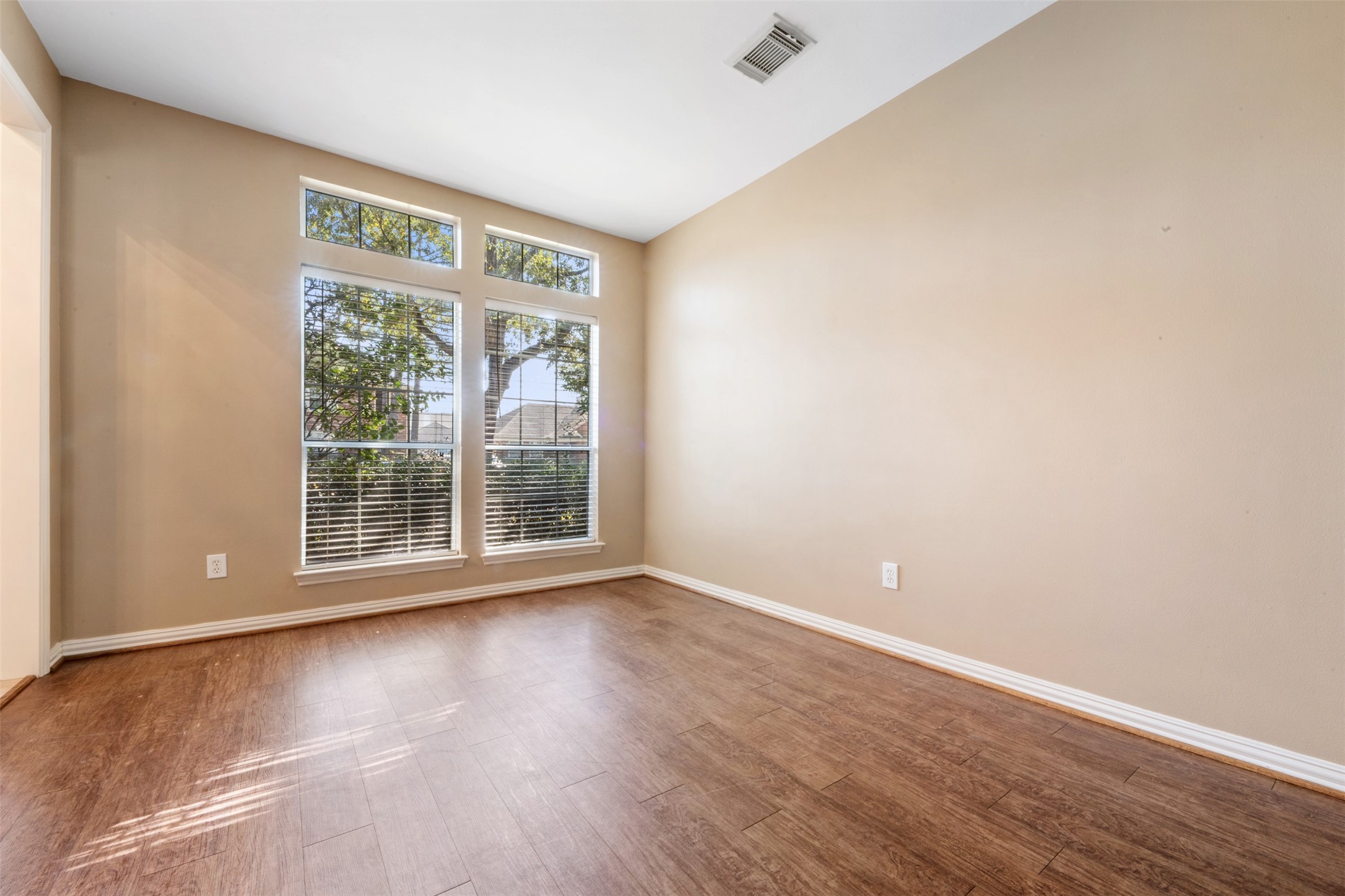 7023 Timber Edge Lane Humble, TX 77346 - Photo 3 of 37 a view of an empty room with wooden floor and a window