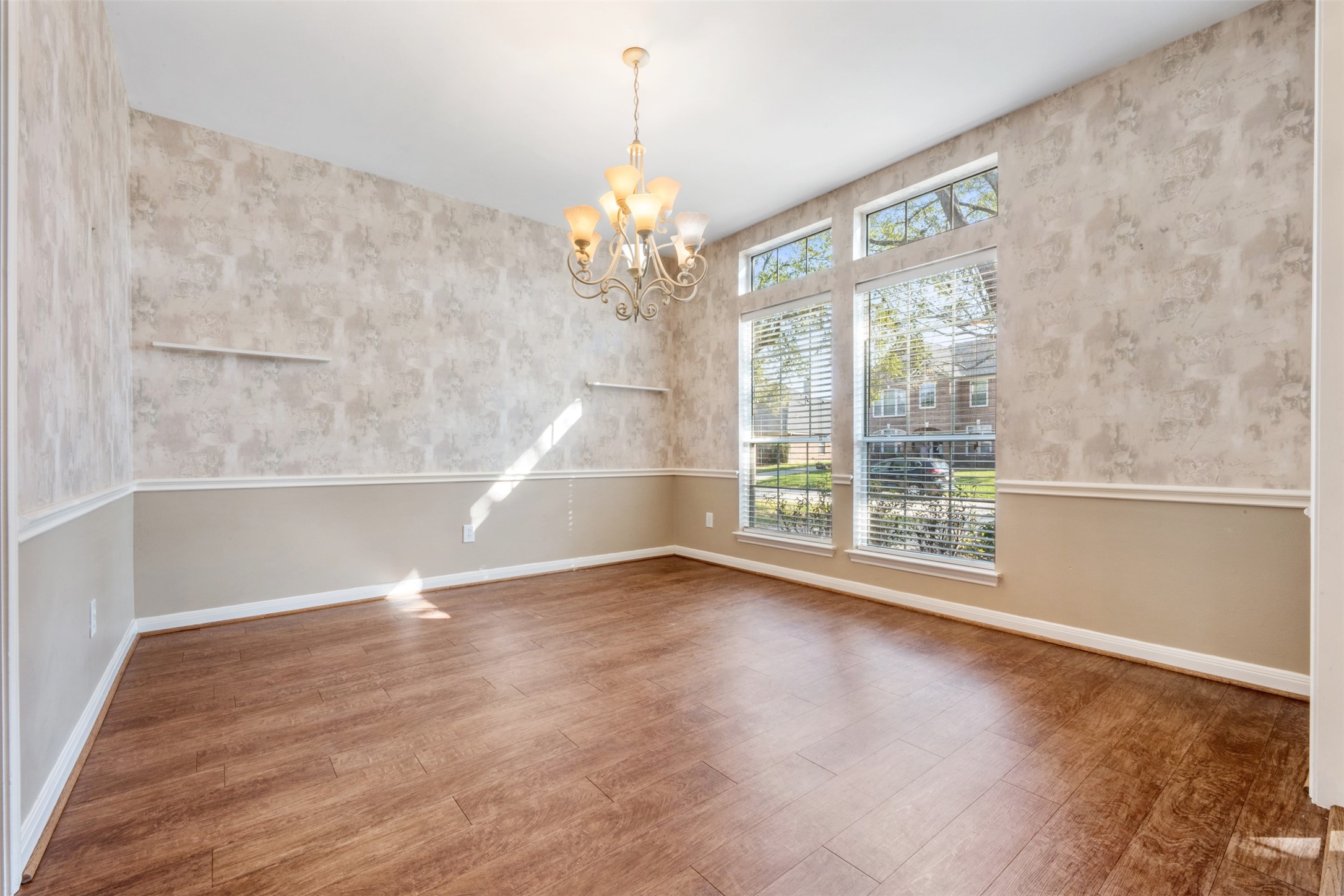 7023 Timber Edge Lane Humble, TX 77346 - Photo 4 of 37 a view of an empty room with wooden floor and a window
