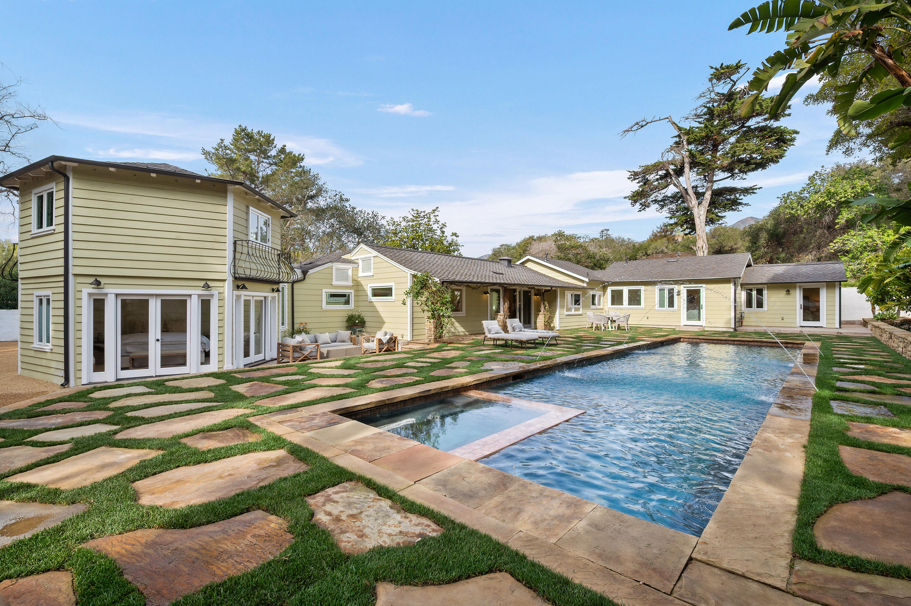 104 La Vereda Road Montecito, CA 93108 - Photo 5 of 15 a front view of a house with a yard table and chairs