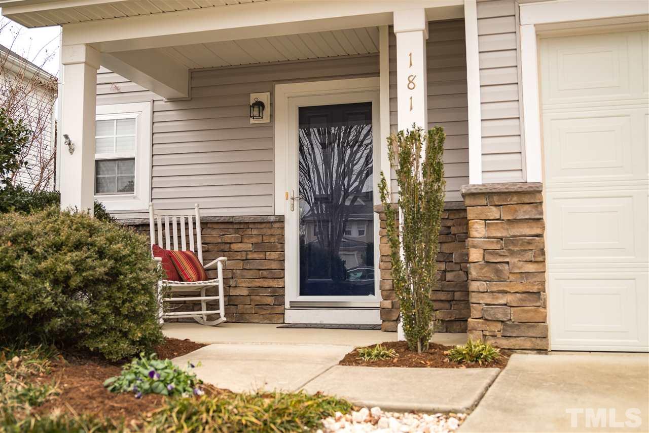 Inviting Covered Porch with Stone Front has Storm Door