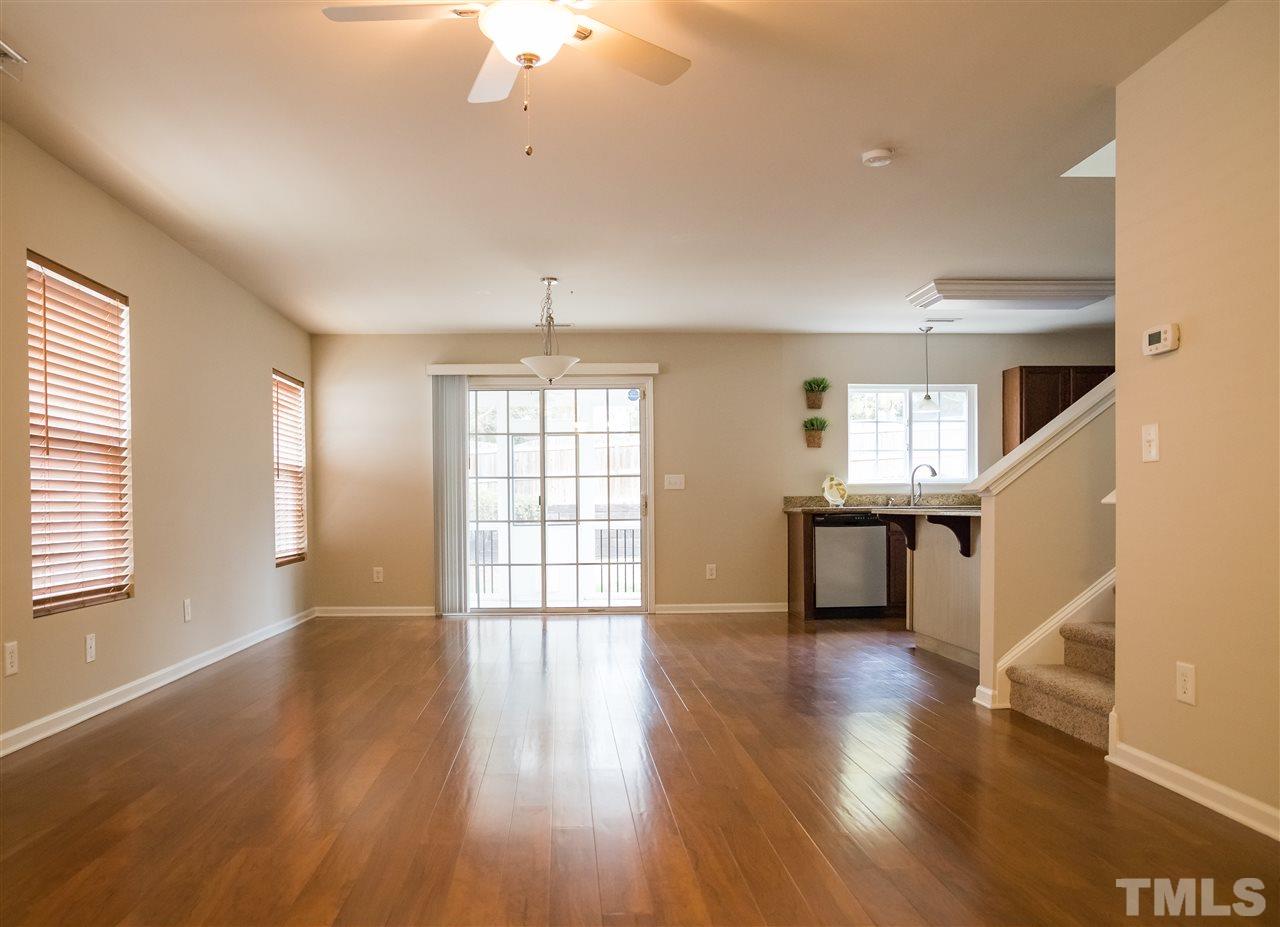Foyer Leads into Family and Dining Areas with Wall of Windows and Wood Type Flooring Extending Throughout First Floor