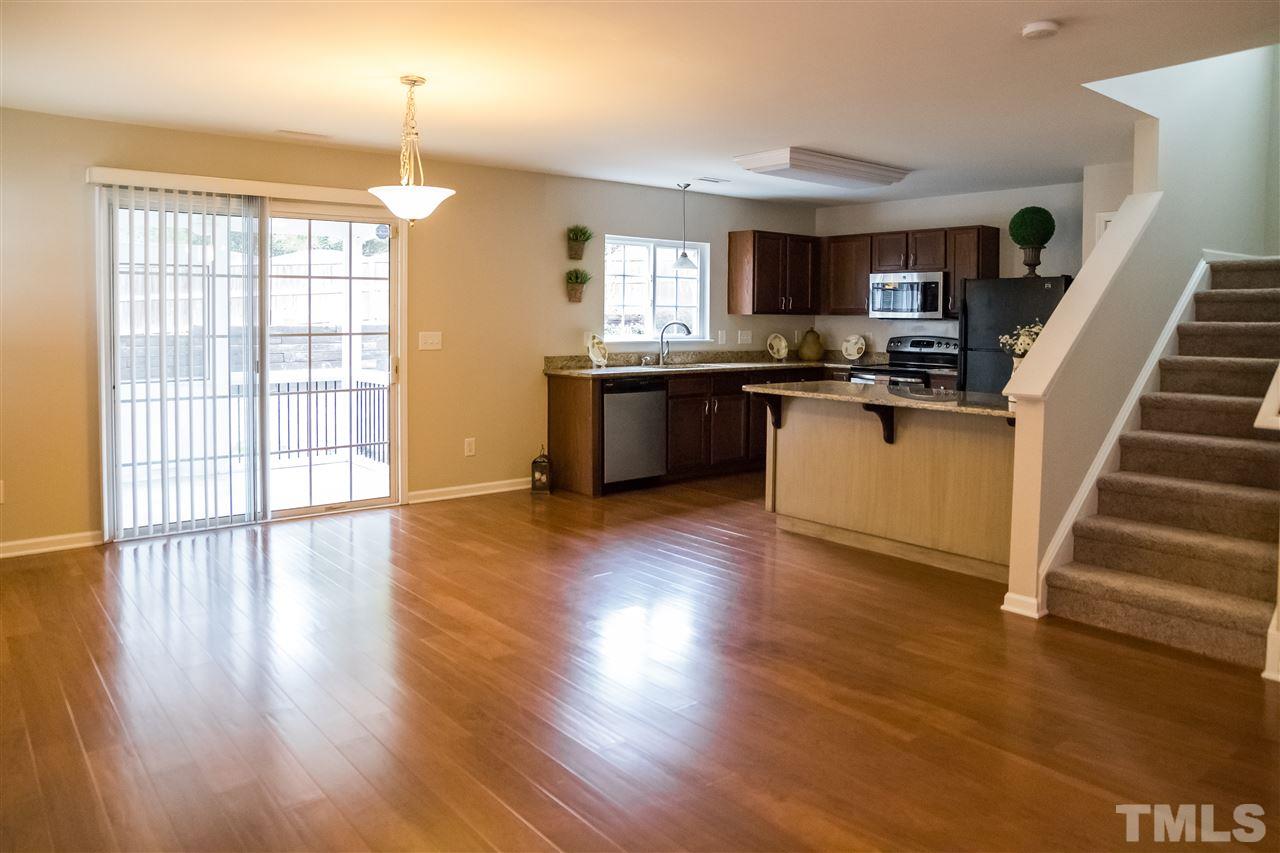 181 Depot Ridge Road Garner, NC 27529 - Photo 21 of 21 Open Floor Plan with Spacious Dining Area Adjacent to Kitchen and Staircase has New Carpet Extending Throughout Upstairs