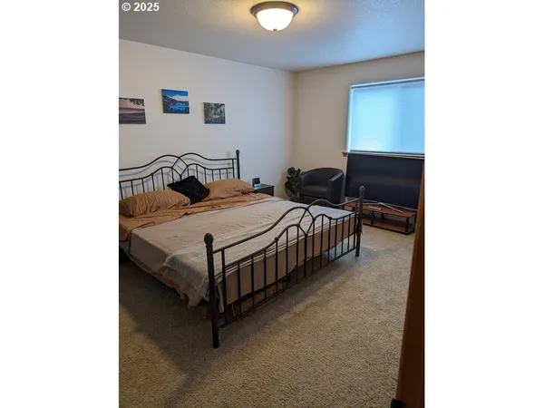 a bedroom with a bed and a lamp with window