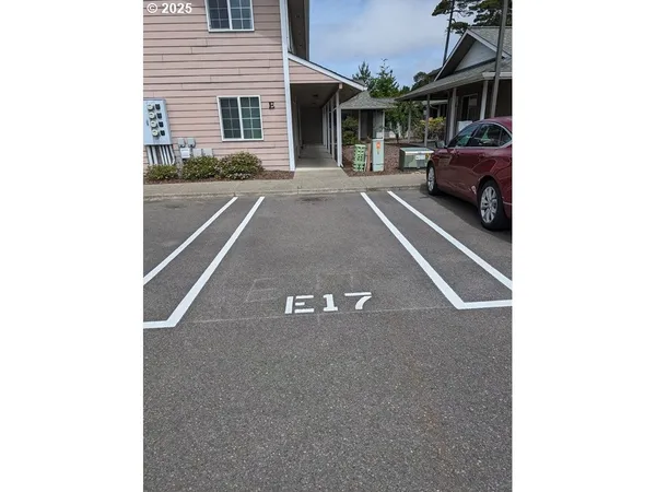 a view of a car park in front of a house