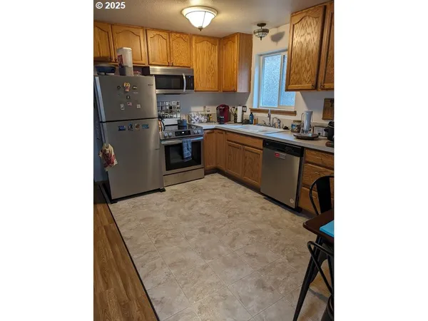a kitchen with a sink appliances and cabinets