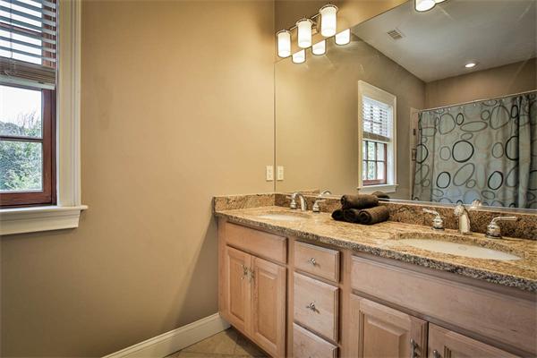 170 Central Avenue Needham, MA 02494 - Photo 25 of 30 a bathroom with a granite countertop sink a mirror and a window