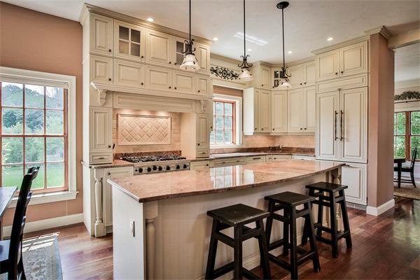 170 Central Avenue Needham, MA 02494 - Photo 7 of 30 a large kitchen with kitchen island a stove a table and chairs in it