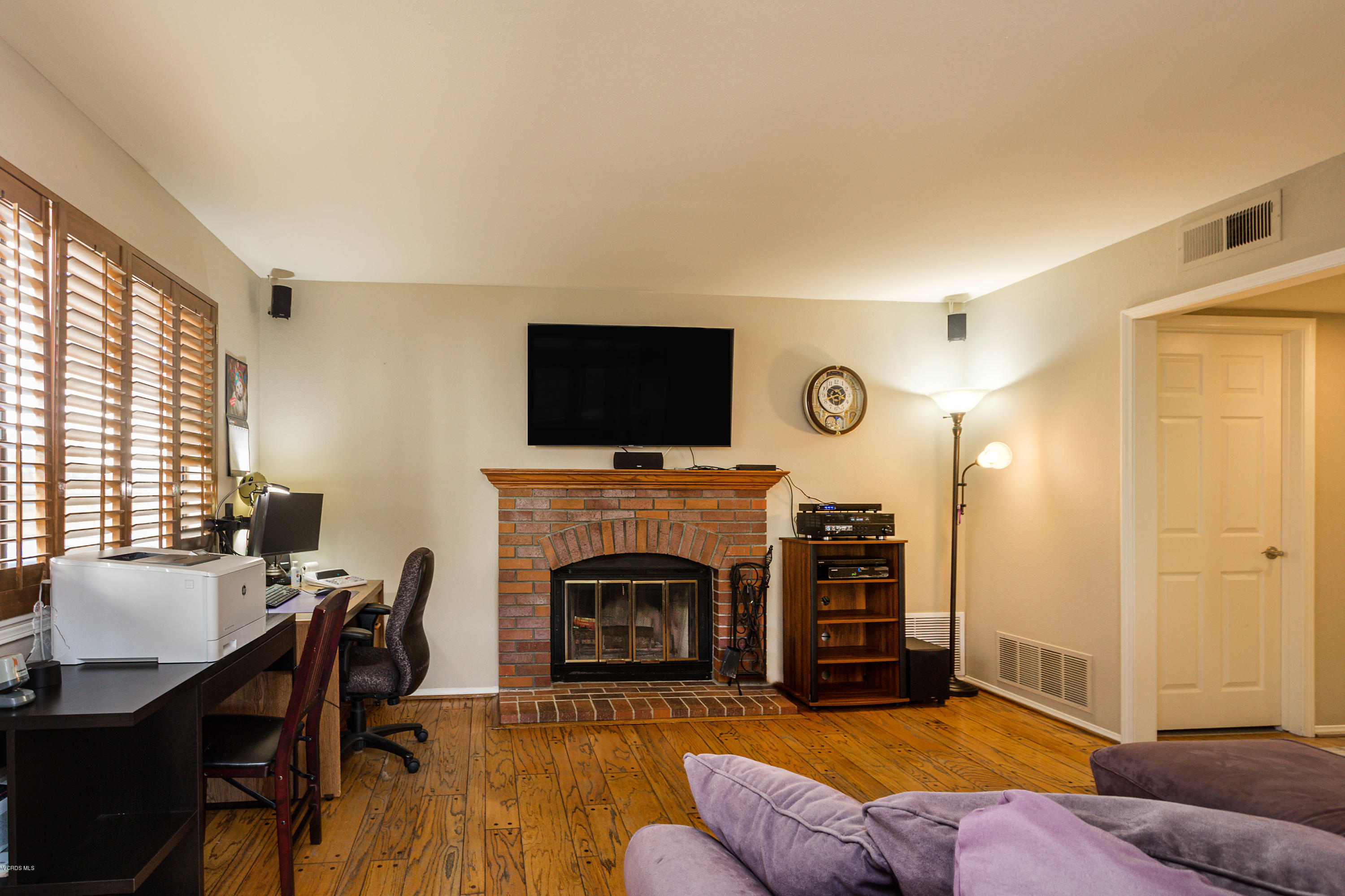 19641 Turtle Springs Way Porter Ranch, CA 91326 - Photo 14 of 31 a living room with furniture flat screen tv and a fireplace