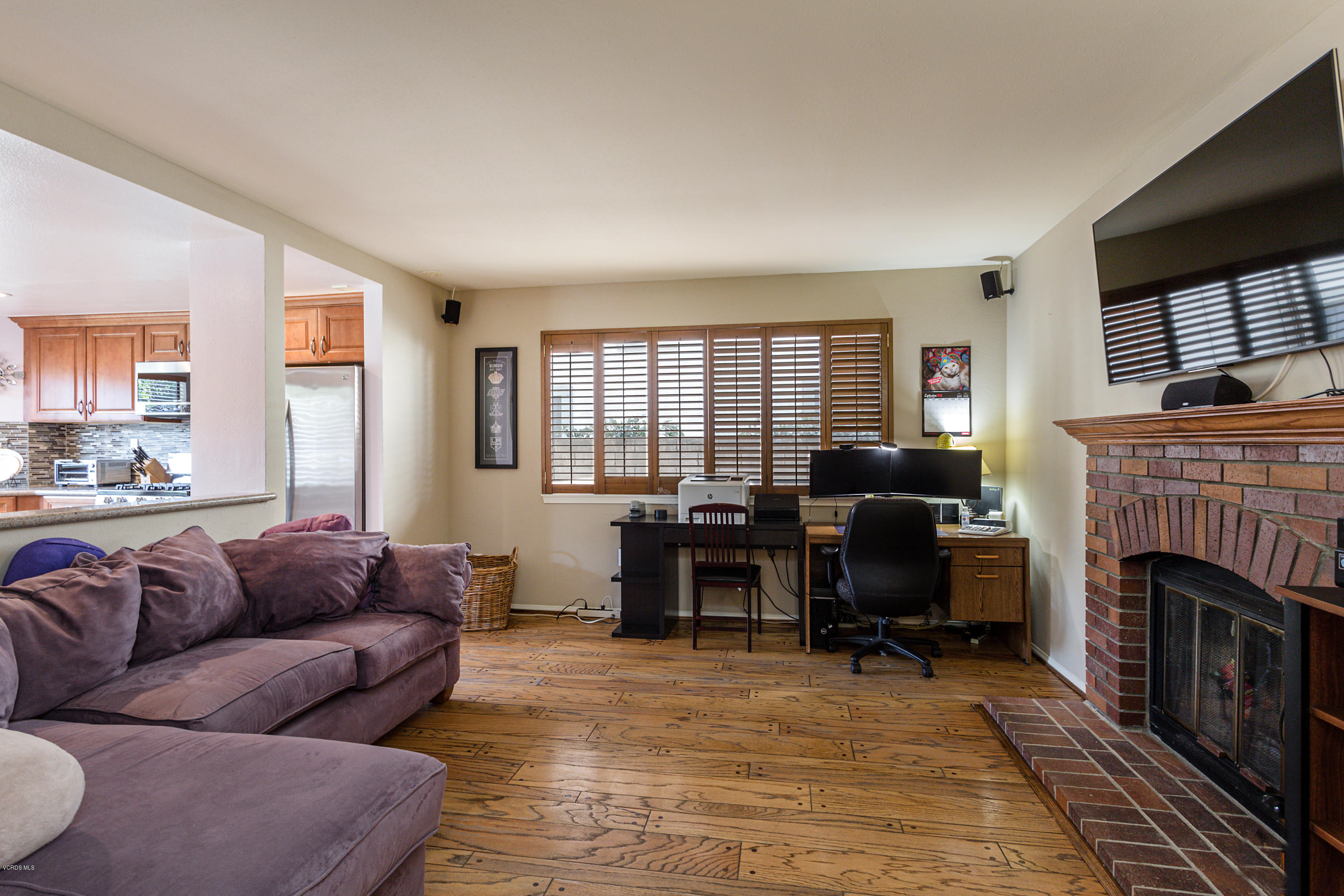 19641 Turtle Springs Way Porter Ranch, CA 91326 - Photo 15 of 31 a living room with furniture a fireplace and a flat screen tv
