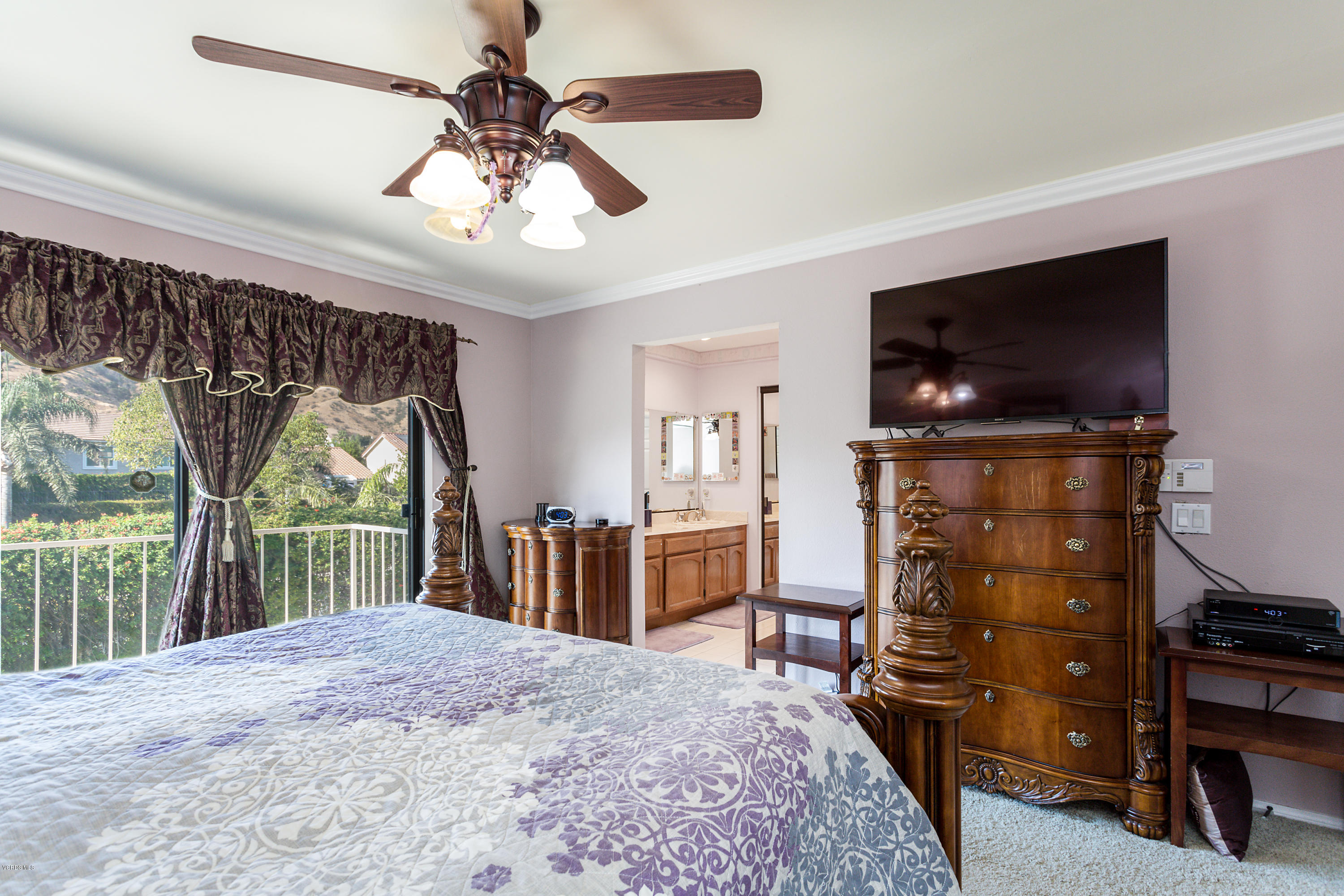 19641 Turtle Springs Way Porter Ranch, CA 91326 - Photo 19 of 31 a bedroom with a bed and a flat tv screen on dresser