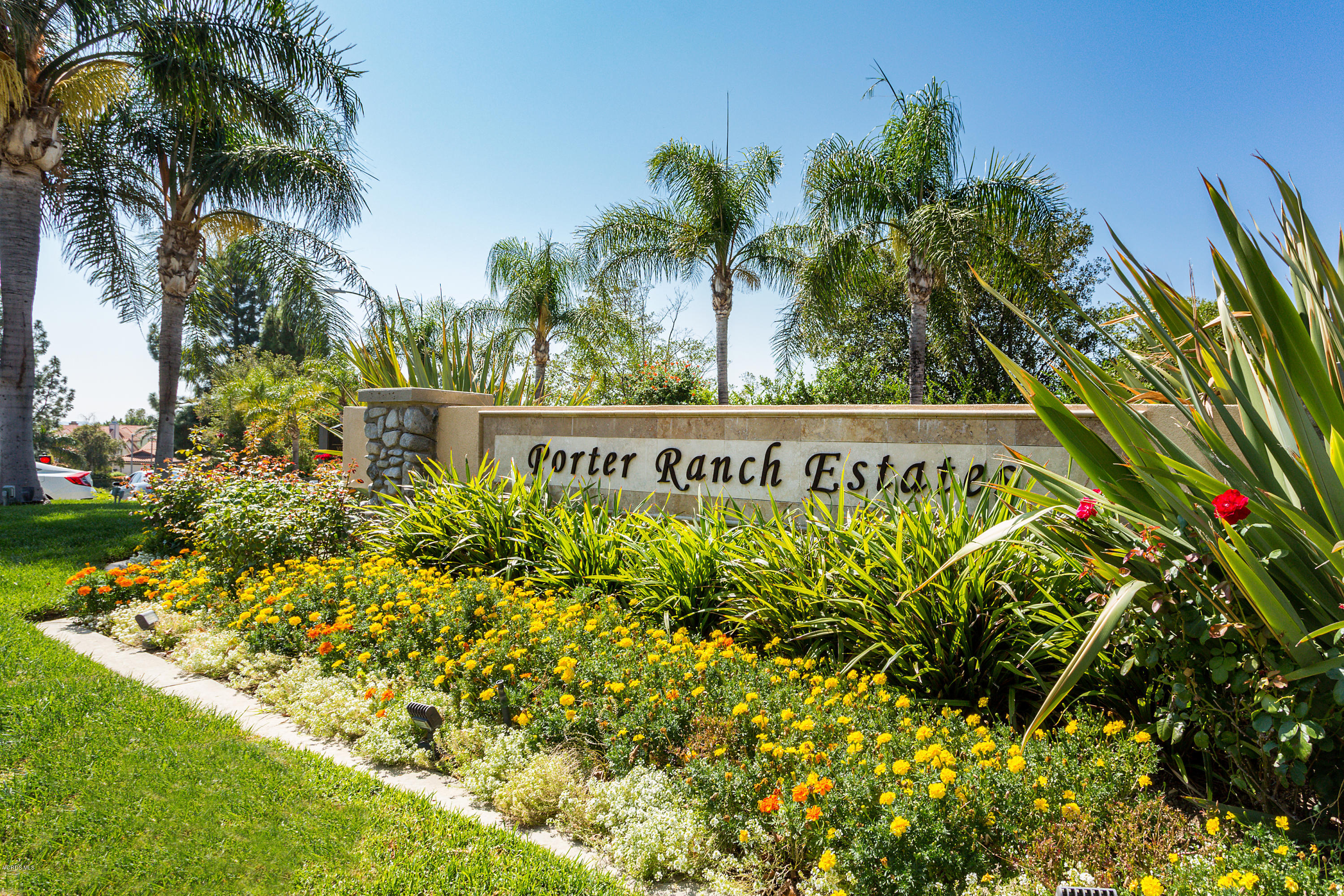 19641 Turtle Springs Way Porter Ranch, CA 91326 - Photo 3 of 31 a sign on a wall with a white fence