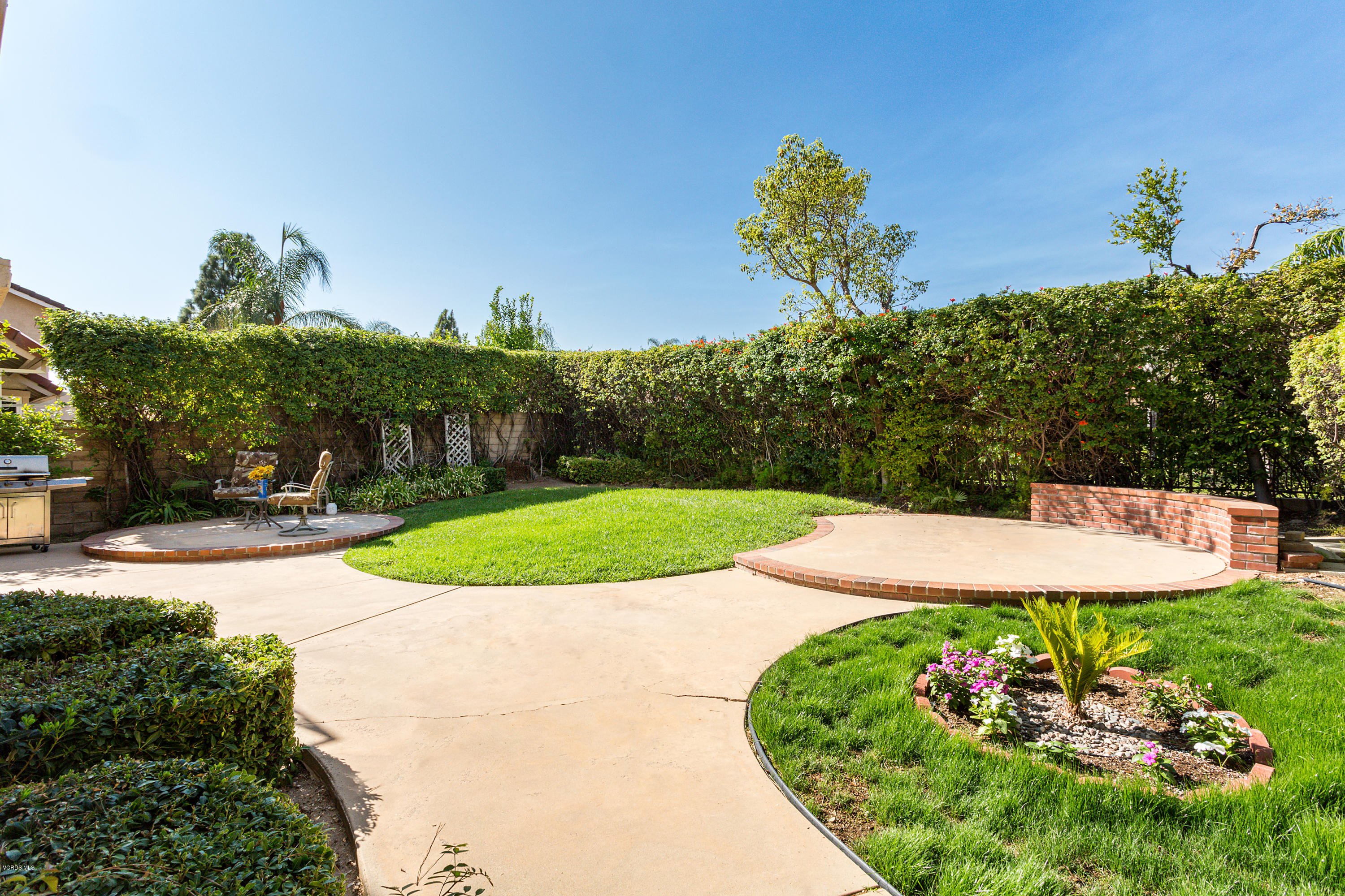 19641 Turtle Springs Way Porter Ranch, CA 91326 - Photo 28 of 31 a view of a garden with a building in the background