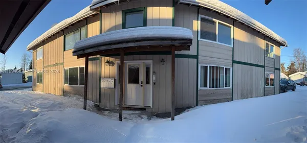 a view of a house with a small yard