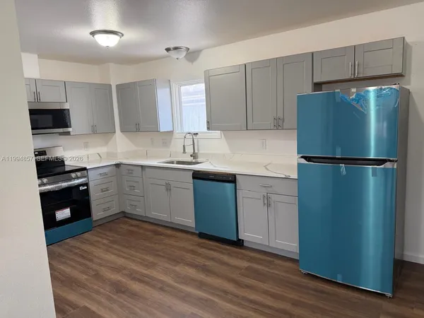 a kitchen with a refrigerator stove and sink