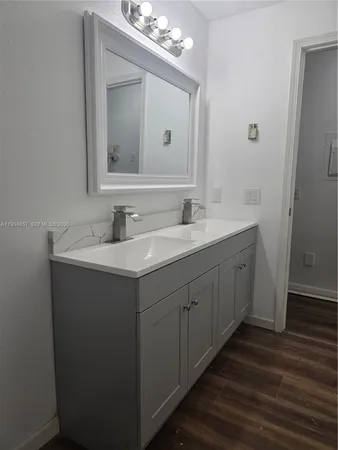 a bathroom with a double vanity sink and mirror