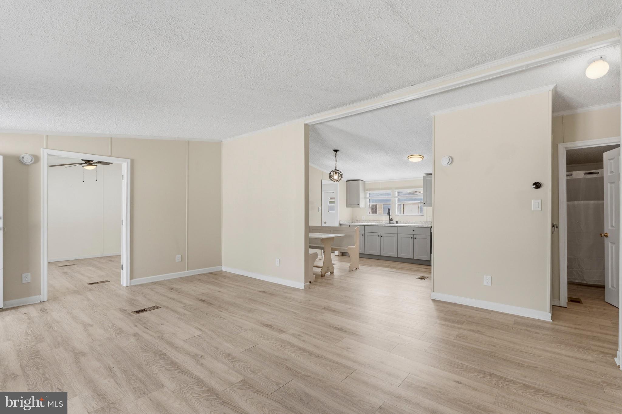 227 Forest Green Road Aberdeen, MD 21001 - Photo 5 of 23 an empty room with wooden floor and a bathroom