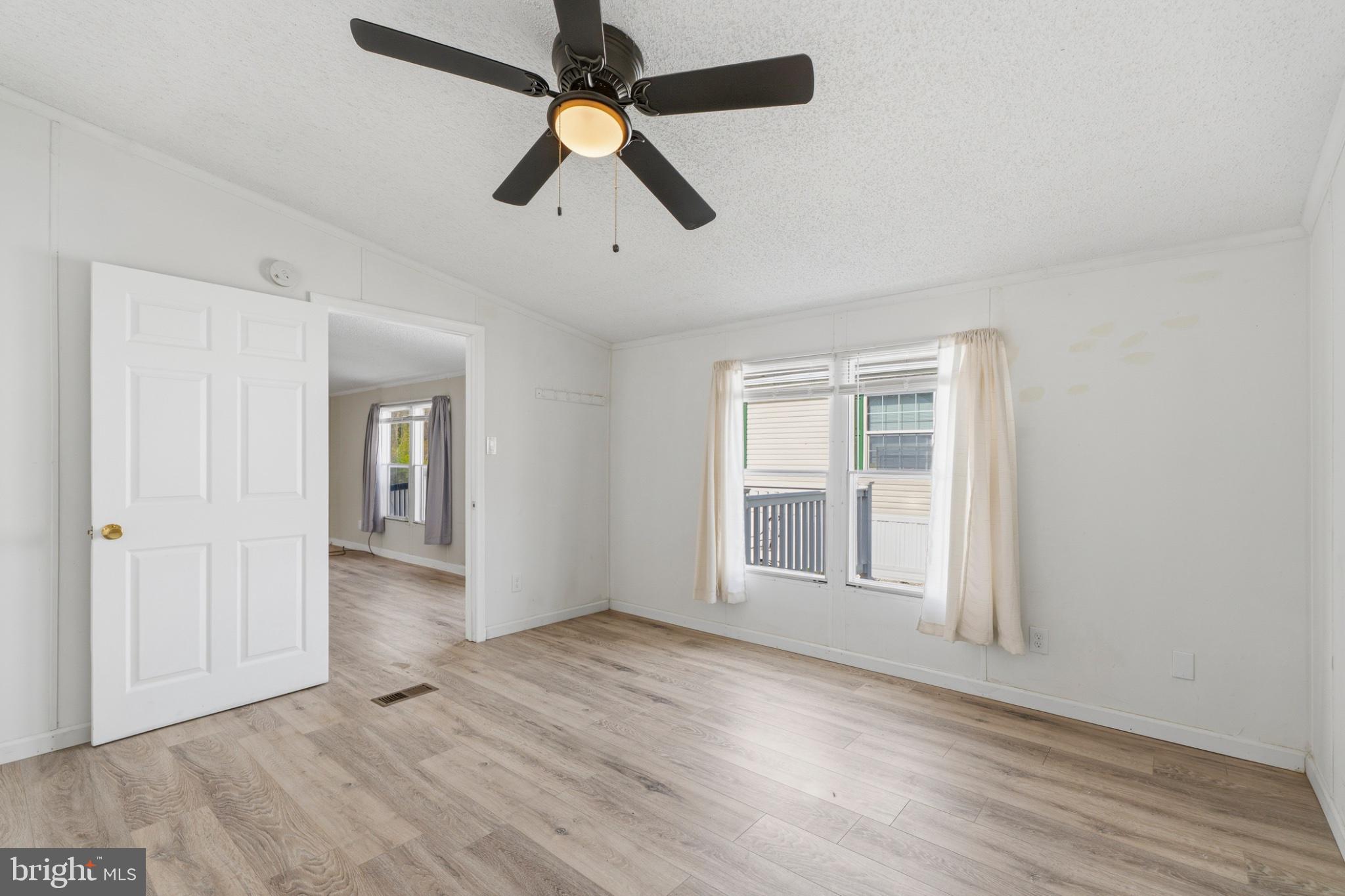 227 Forest Green Road Aberdeen, MD 21001 - Photo 10 of 23 wooden floor in an empty room with a window