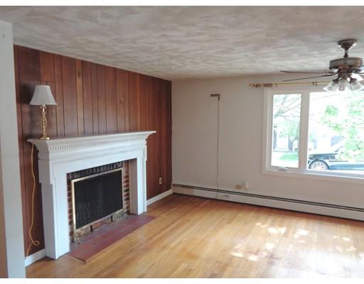 8 Russell Street Watertown, MA 02472 - Photo 4 of 9 a view of empty room with wooden floor and fireplace