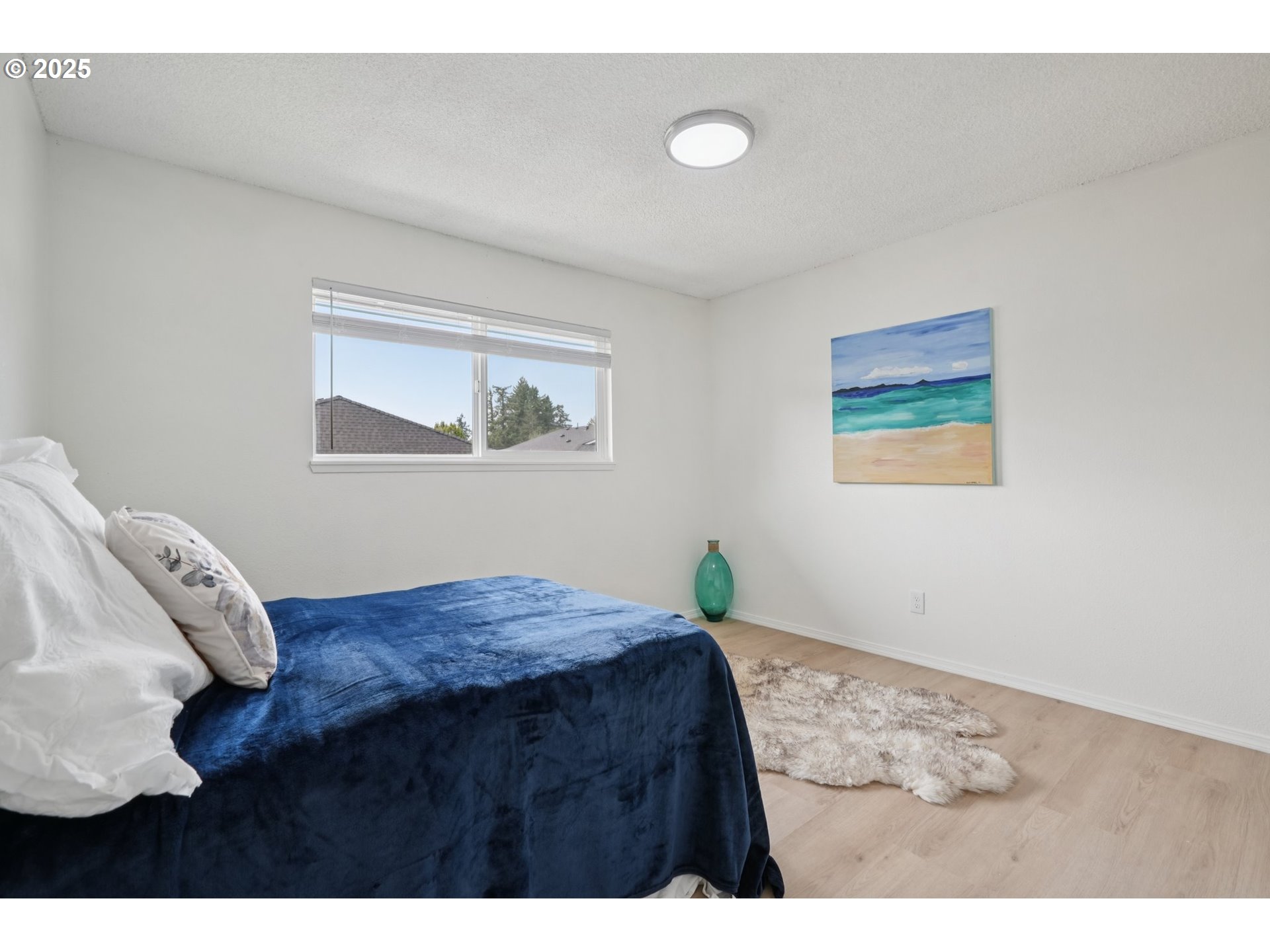 1495 Northeast Kane Drive Gresham, OR 97030 - Photo 29 of 48 a bedroom with a bed and a painting on the wall