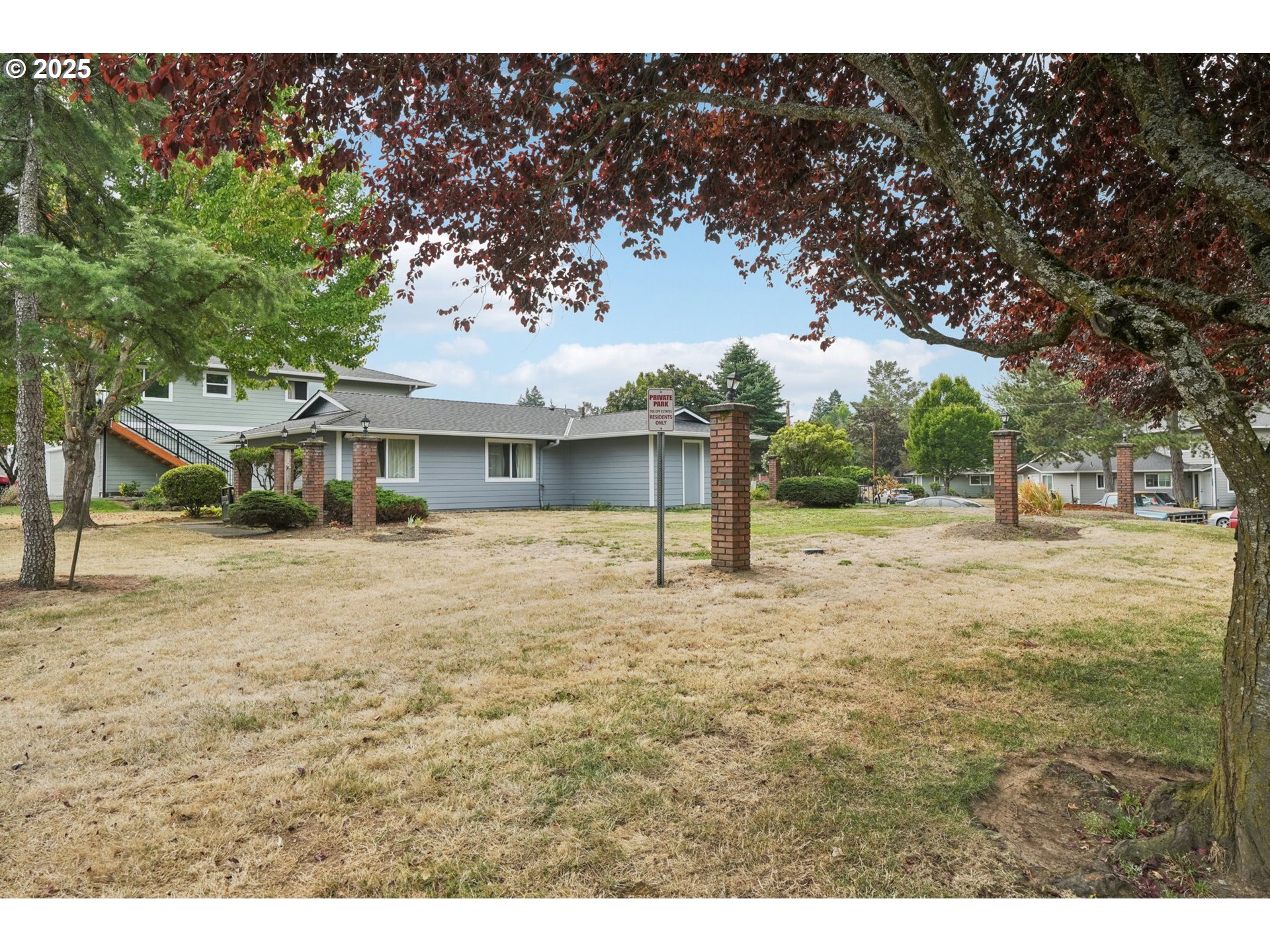 1495 Northeast Kane Drive Gresham, OR 97030 - Photo 36 of 48 a front view of a house with a yard