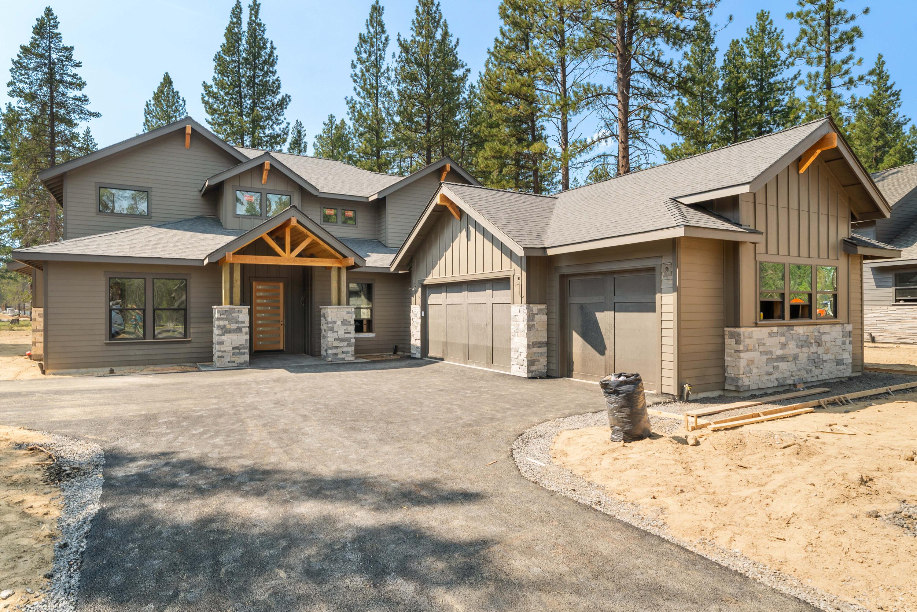 17780 Preservation Loop, Unit 486 Bend, OR 97707 - Photo 1 of 3 a front view of a house with a yard and garage