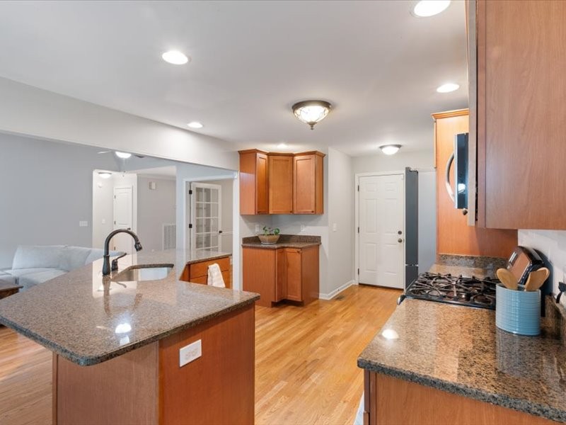 3904 Rowland Road Murfreesboro, TN 37128 - Photo 12 of 26 a kitchen with stainless steel appliances granite countertop a sink a stove and a wooden floors