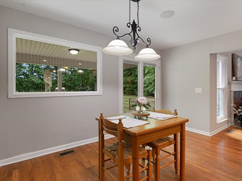 3904 Rowland Road Murfreesboro, TN 37128 - Photo 13 of 26 a dining room with wooden floor a chandelier a wooden table and chairs