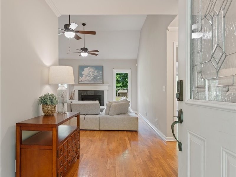 3904 Rowland Road Murfreesboro, TN 37128 - Photo 5 of 26 a living room with furniture a fireplace and a chandelier