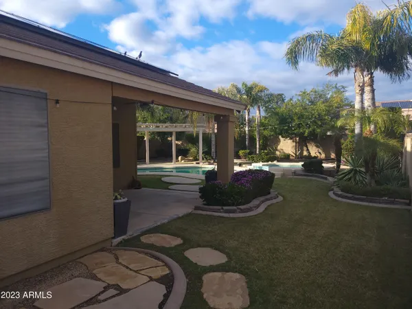a view of a porch with furniture and a yard