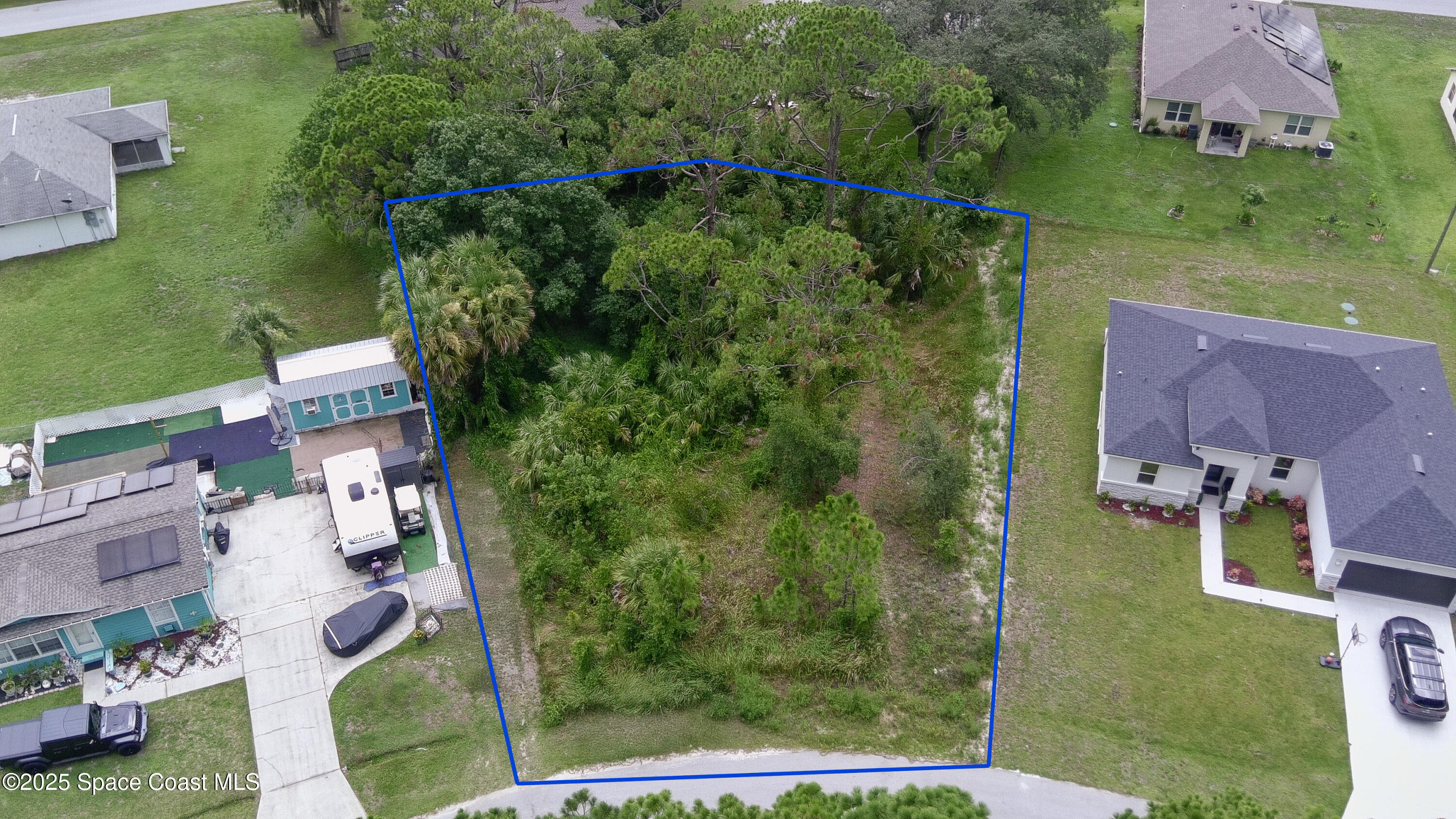 405 Tilhal Road Southwest Palm Bay, FL 32908 - Photo 1 of 13 an aerial view of residential house with outdoor space and parking