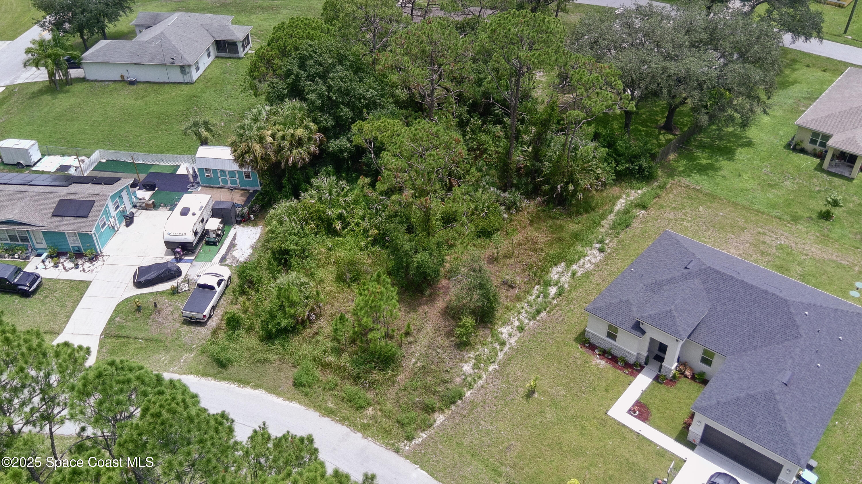 405 Tilhal Road Southwest Palm Bay, FL 32908 - Photo 3 of 13 an aerial view of multiple houses with yard