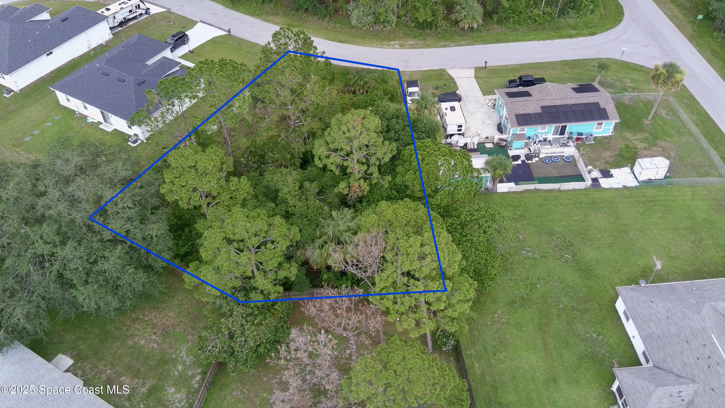 405 Tilhal Road Southwest Palm Bay, FL 32908 - Photo 8 of 13 an aerial view of residential houses with outdoor space and trees