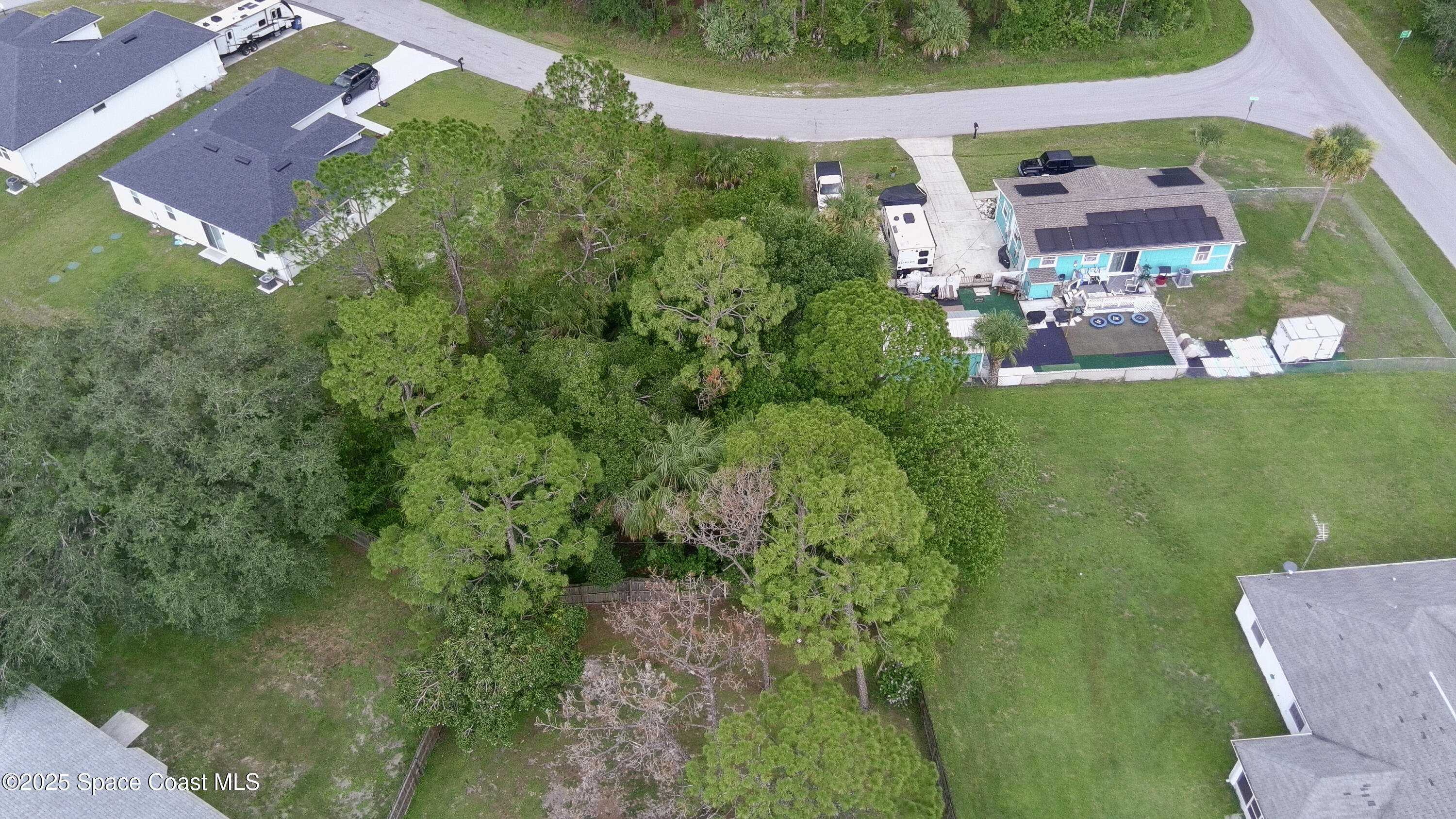 405 Tilhal Road Southwest Palm Bay, FL 32908 - Photo 9 of 13 an aerial view of residential houses with outdoor space and trees