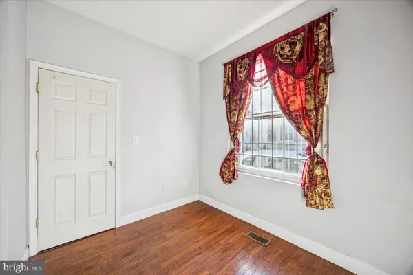 an entryway with bed and wooden floor